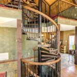 Rustic Home with Decorative, Wrought Iron Spiral Stair