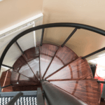 dark stained wood treads on steel spiral stair