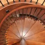 top down view of forged iron spiral staircase with solid wood red oak treads and handrail